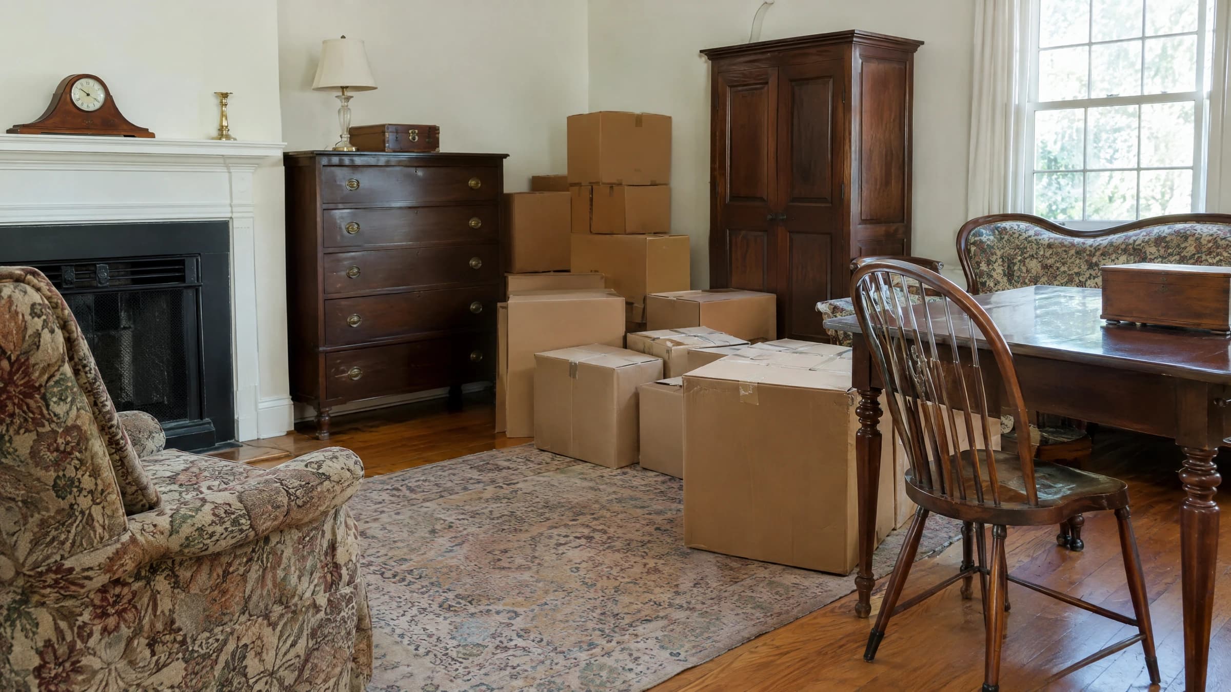 Older furniture and closed household boxes in a living room.