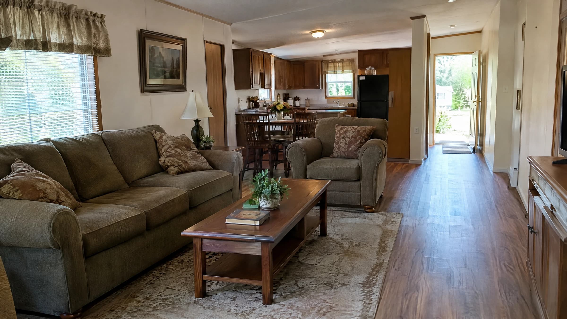 Loose furniture inside a mobile home with a clear passage to the exterior door.