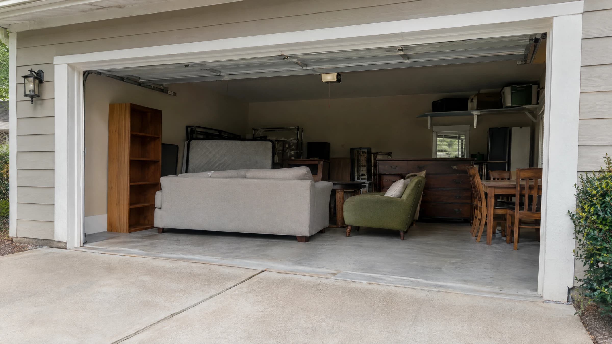 Household furniture visible inside an open residential garage.
